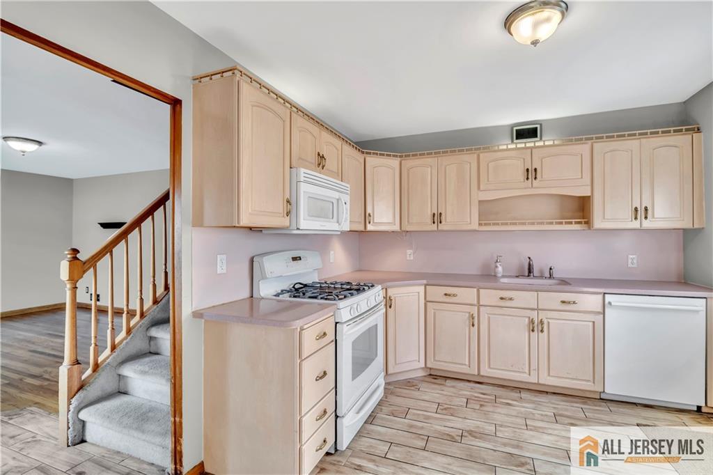 306 Austin Avenue Old Bridge, NJ 08857 - Photo 13 of 39 a kitchen with stainless steel appliances granite countertop a stove a sink and a refrigerator