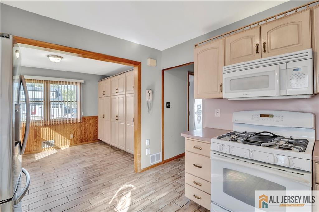 306 Austin Avenue Old Bridge, NJ 08857 - Photo 14 of 39 a kitchen with white cabinets and white appliances