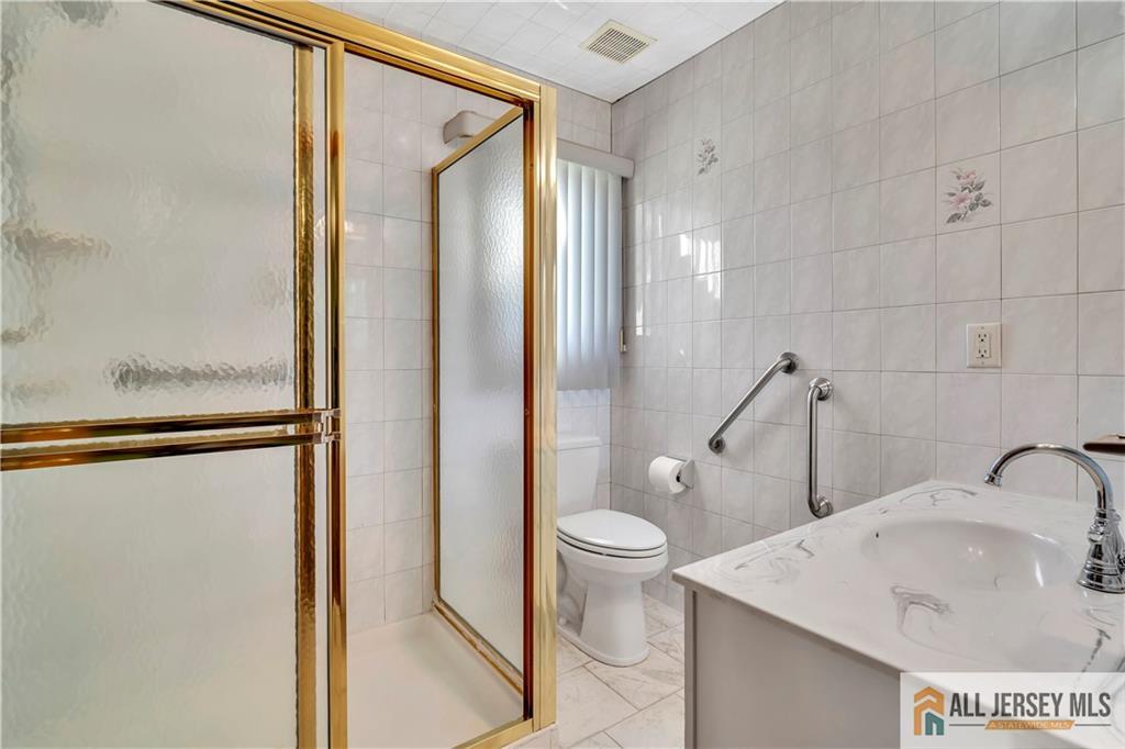 306 Austin Avenue Old Bridge, NJ 08857 - Photo 24 of 39 a bathroom with a sink toilet and shower
