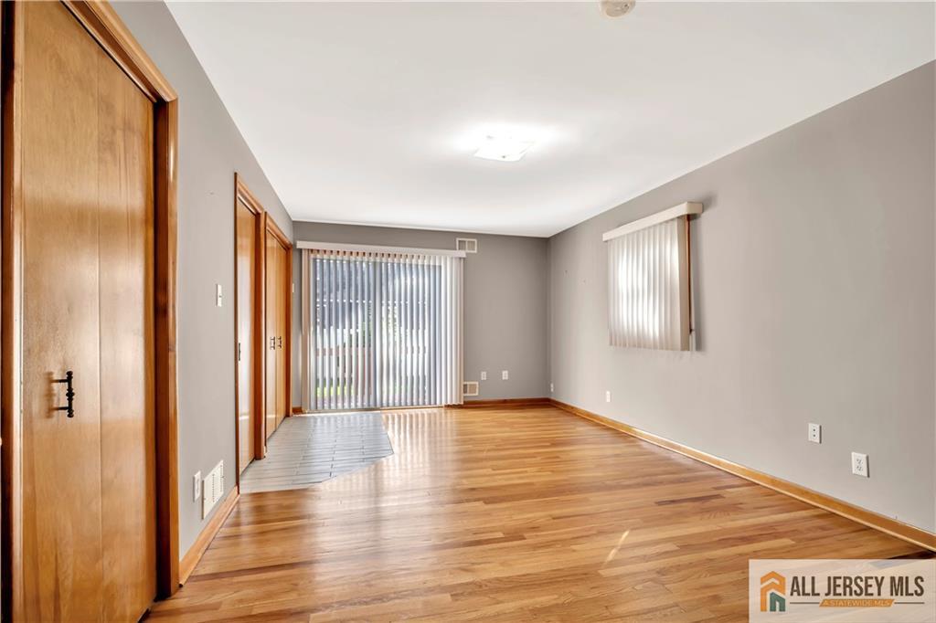 306 Austin Avenue Old Bridge, NJ 08857 - Photo 25 of 39 a view of an empty room with wooden floor and a window
