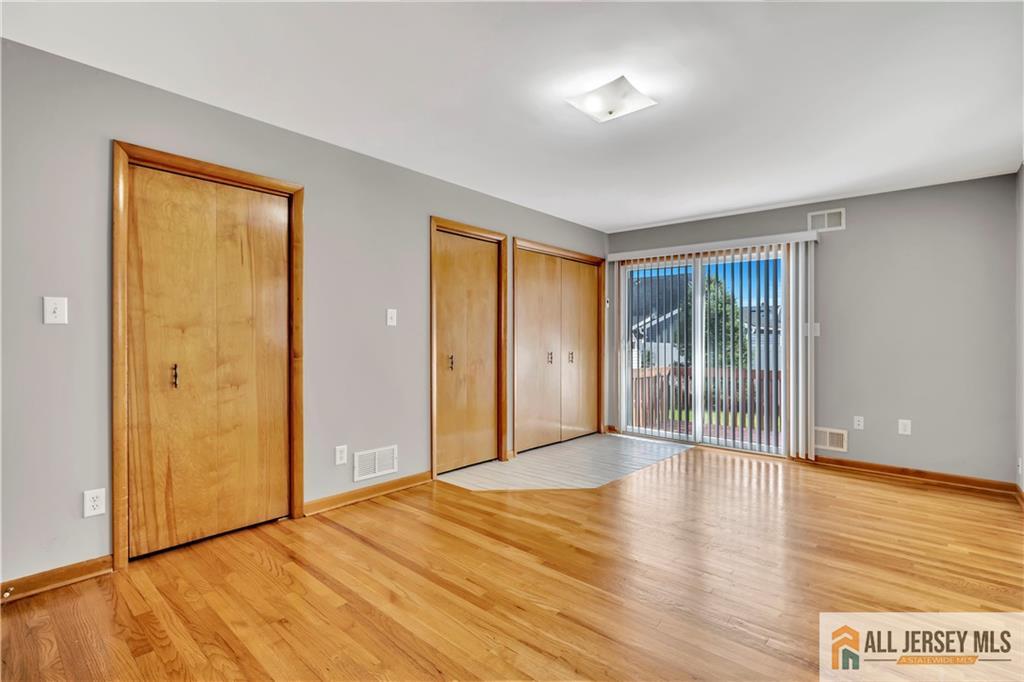 306 Austin Avenue Old Bridge, NJ 08857 - Photo 26 of 39 a view of an empty room with wooden floor and a window