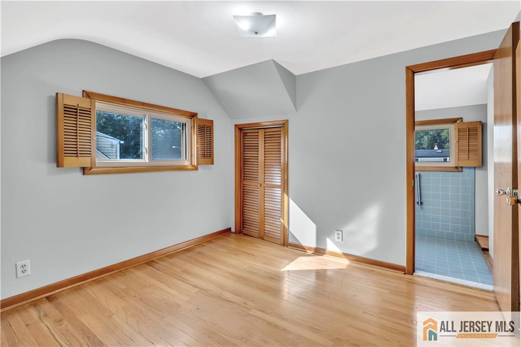 306 Austin Avenue Old Bridge, NJ 08857 - Photo 28 of 39 a view of an empty room with wooden floor and a window