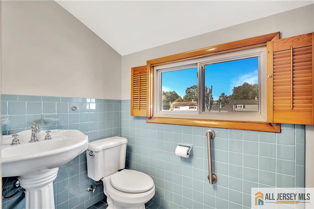 306 Austin Avenue Old Bridge, NJ 08857 - Photo 29 of 39 a bathroom with a toilet a sink and mirror