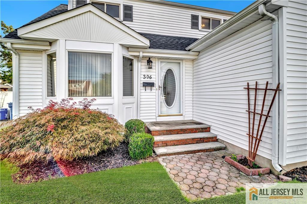 306 Austin Avenue Old Bridge, NJ 08857 - Photo 3 of 39 a front view of a house with a garden