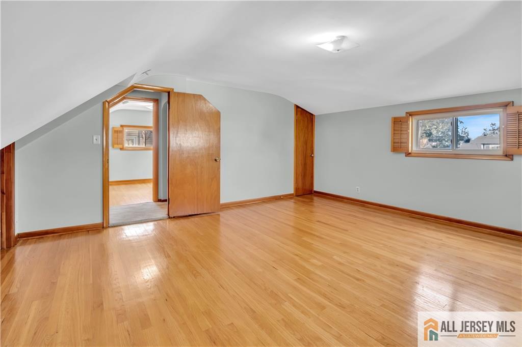 306 Austin Avenue Old Bridge, NJ 08857 - Photo 32 of 39 a view of an empty room with wooden floor and a window