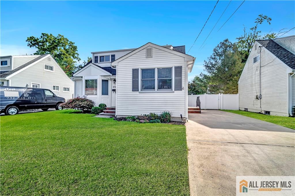 306 Austin Avenue Old Bridge, NJ 08857 - Photo 5 of 39 a front view of a house with a yard and garage