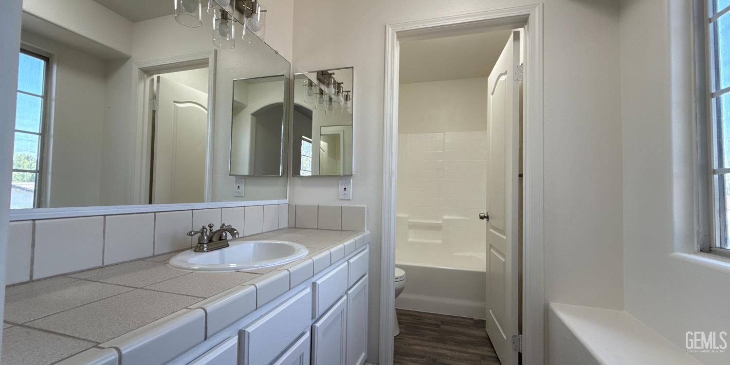 Undisclosed Address Bakersfield, CA 93312 - Photo 13 of 20 a bathroom with a sink and a mirror