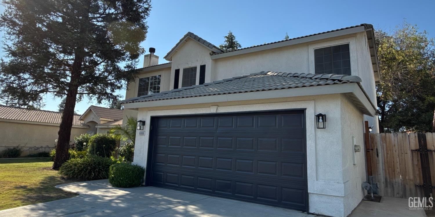 Undisclosed Address Bakersfield, CA 93312 - Photo 2 of 20 a front view of a house with a garden