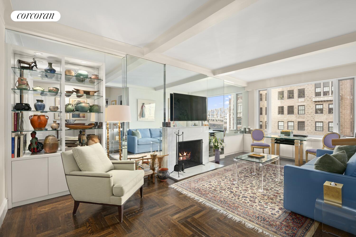 2 Sutton Place South, Unit 11B Manhattan, NY 10022 - Photo 1 of 10 a living room with furniture fireplace and flat screen tv