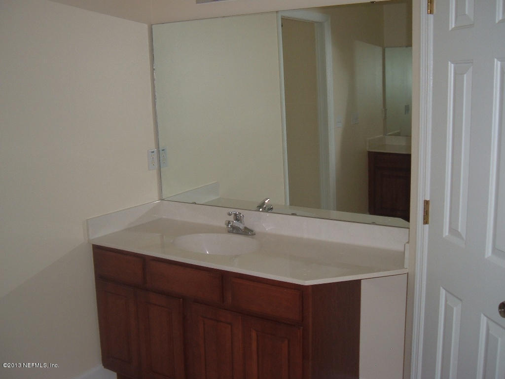 19 Russkin Lane Palm Coast, FL 32164 - Photo 19 of 28 a bathroom with a sink and a mirror