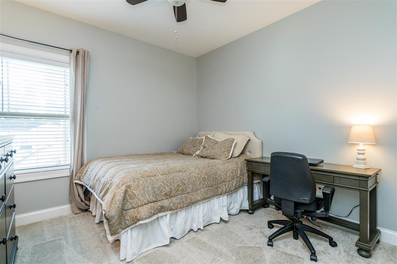 1528 Rodessa Run Raleigh, NC 27607 - Photo 25 of 30 Upstairs bedroom with closet with wooden shelving, new carpet and a ceiling fan. Bedroom