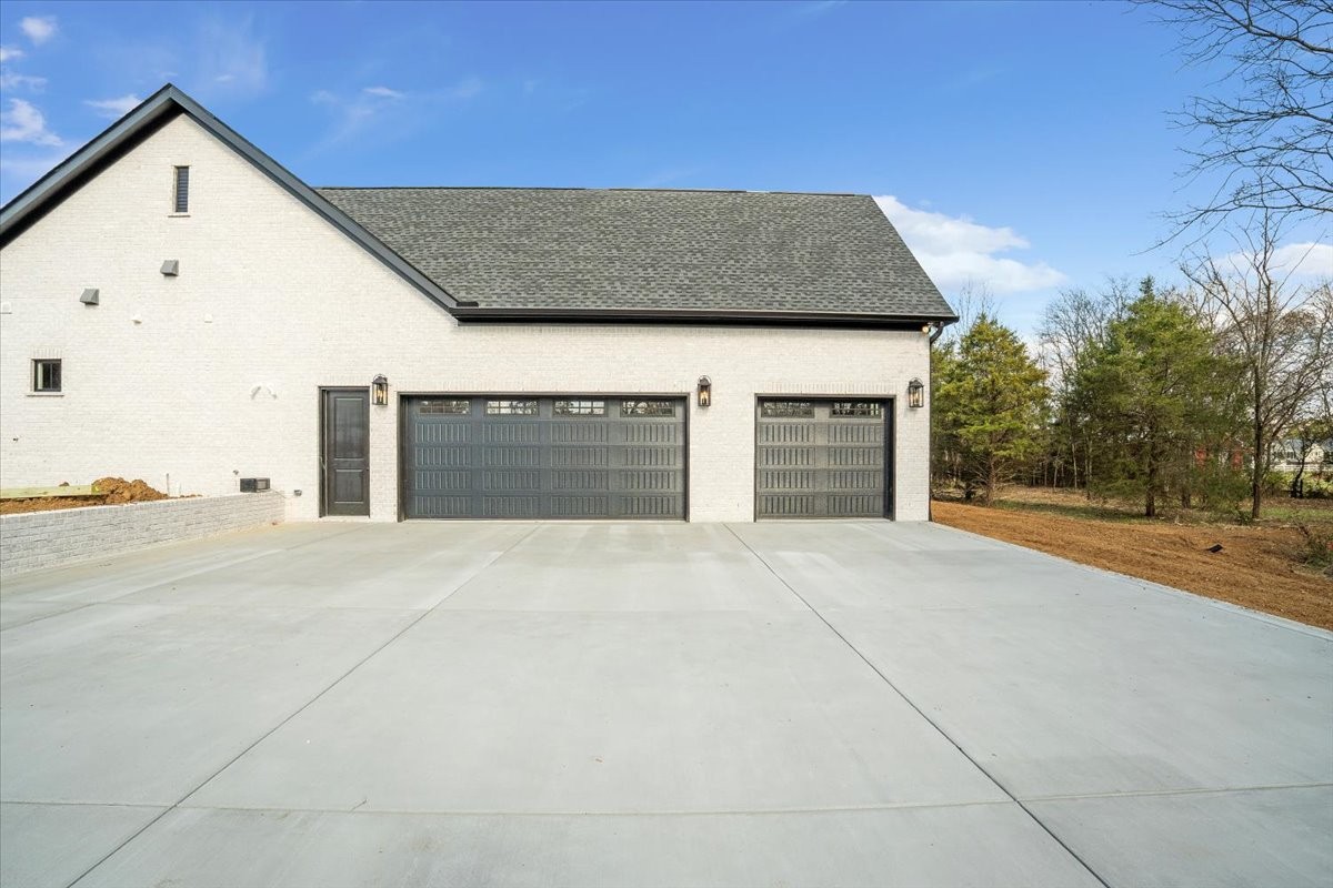 2412 Joe Brown Road Spring Hill, TN 37174 - Photo 38 of 86 a front view of a house with a yard and garage
