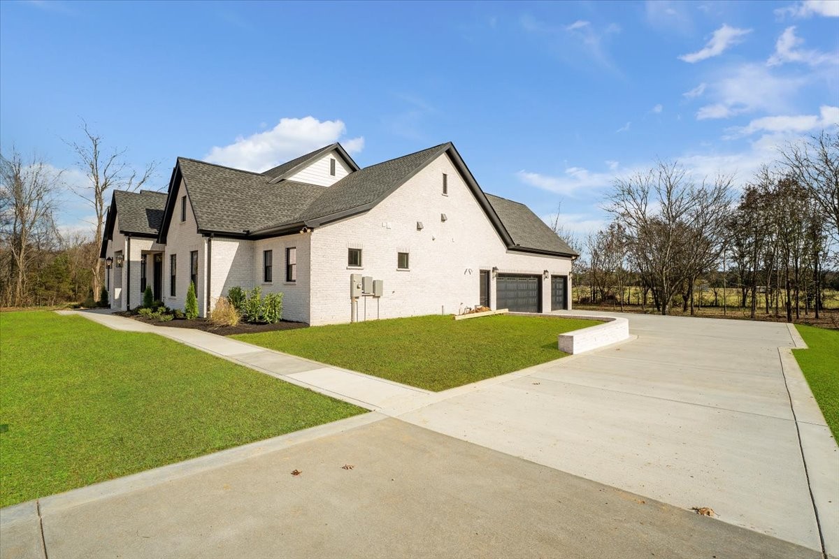 2412 Joe Brown Road Spring Hill, TN 37174 - Photo 40 of 86 a front view of a house with a yard and garage
