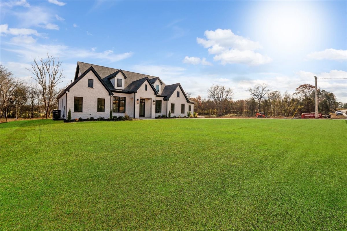 2412 Joe Brown Road Spring Hill, TN 37174 - Photo 43 of 86 a large house with a big yard and large trees