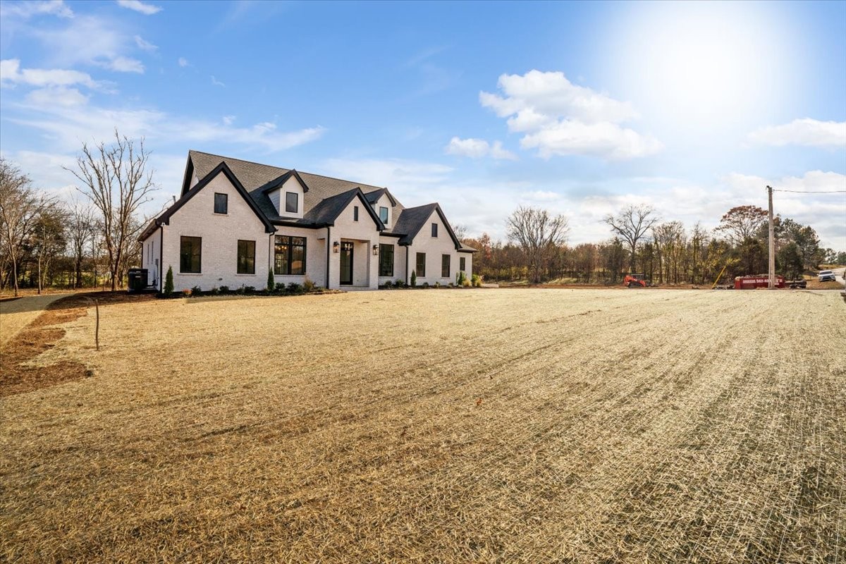 2412 Joe Brown Road Spring Hill, TN 37174 - Photo 44 of 86 a view of a large house with a big yard and large trees