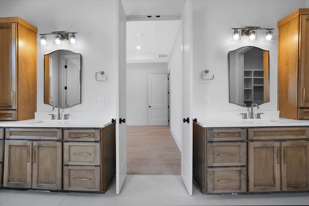 2412 Joe Brown Road Spring Hill, TN 37174 - Photo 64 of 86 a spacious bathroom with a double vanity sink double and mirror