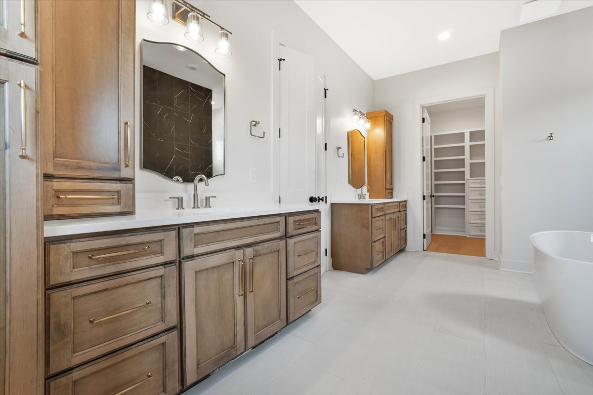 2412 Joe Brown Road Spring Hill, TN 37174 - Photo 70 of 86 a spacious bathroom with a double vanity sink a mirror and shower