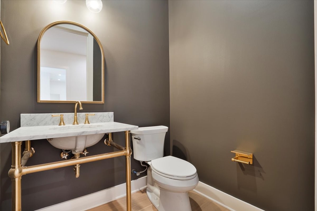 2412 Joe Brown Road Spring Hill, TN 37174 - Photo 76 of 86 a bathroom with a toilet a sink and mirror