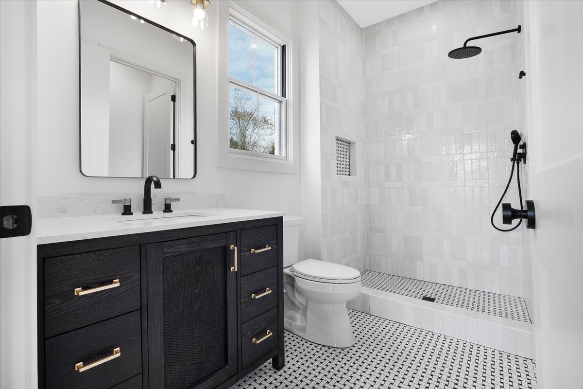 2412 Joe Brown Road Spring Hill, TN 37174 - Photo 81 of 86 a bathroom with a sink a toilet a mirror and shower