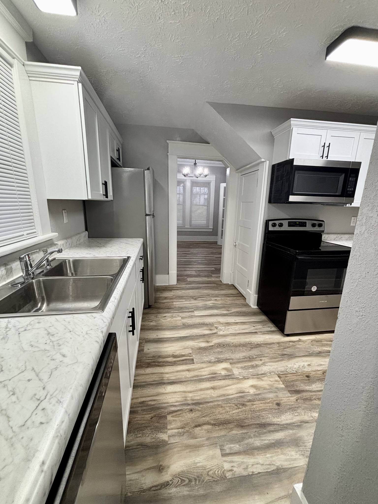 40 Line Street Cadiz, KY 42211 - Photo 11 of 53 a kitchen with stainless steel appliances granite countertop a sink and stove top oven