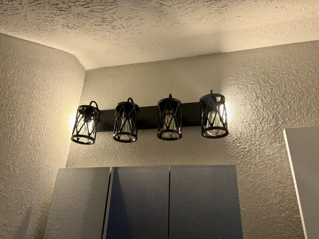 an empty room with fireplace fan and windows