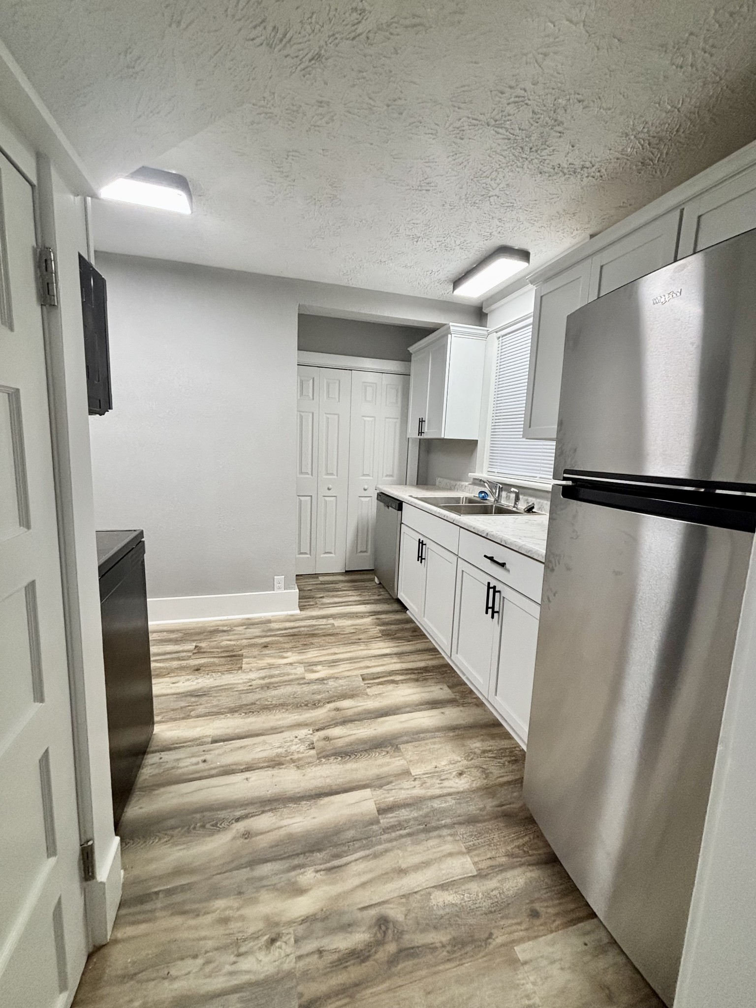 40 Line Street Cadiz, KY 42211 - Photo 7 of 53 a kitchen with white cabinets and refrigerator