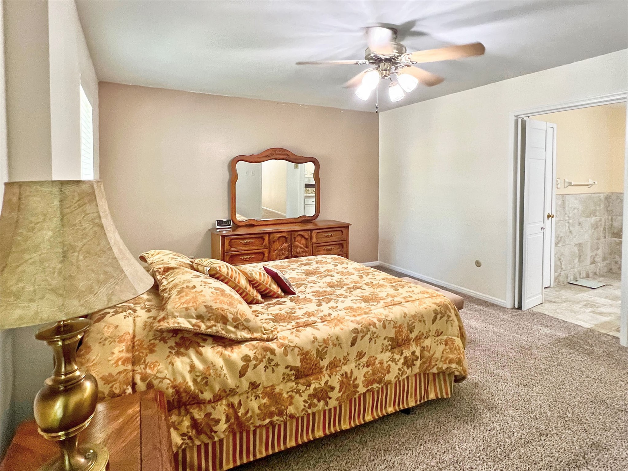 16902 Summit Oaks Lane Spring, TX 77379 - Photo 30 of 49 a bedroom with a bed and a chandelier