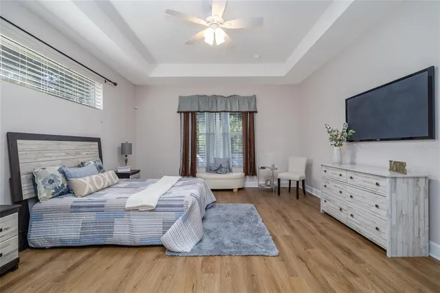 a bedroom with a bed and flat screen tv