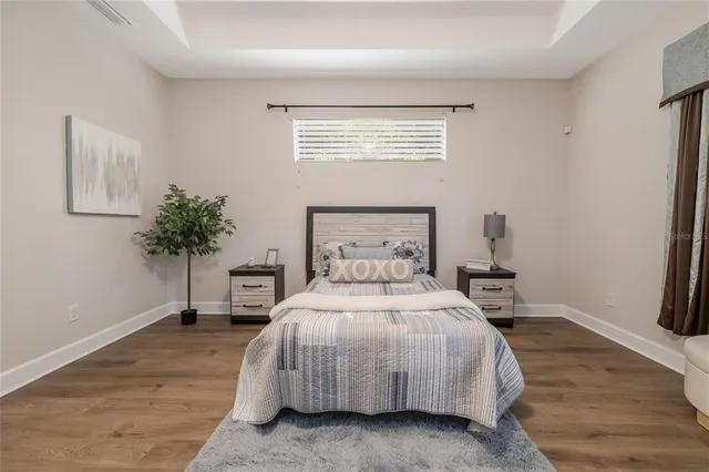 a bedroom with a bed and a potted plant