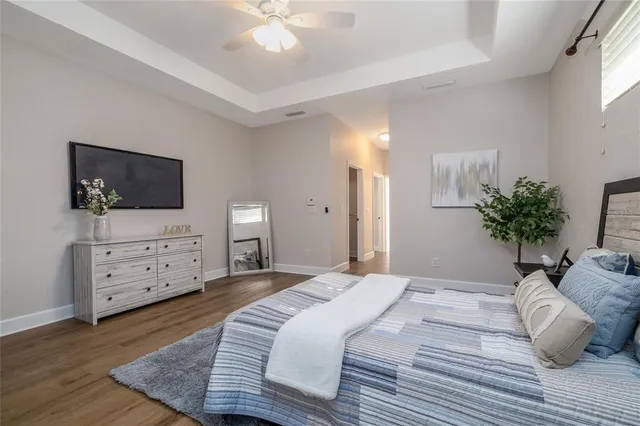 a bedroom with a bed and flat screen tv