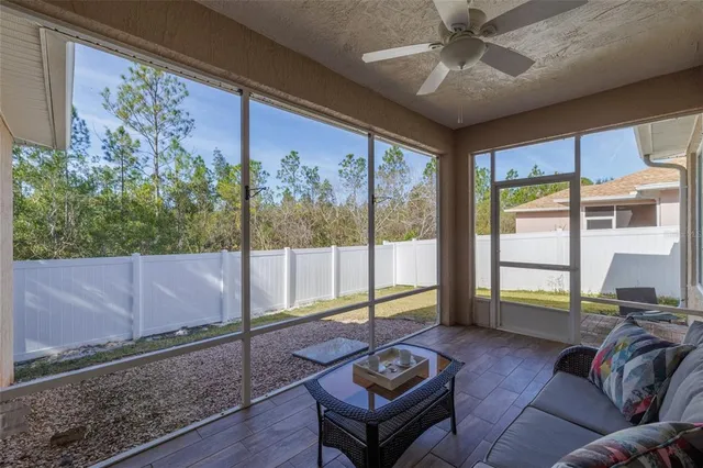 a living room with furniture and a floor to ceiling window