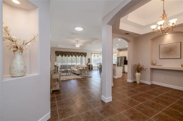 a lobby with furniture and a chandelier
