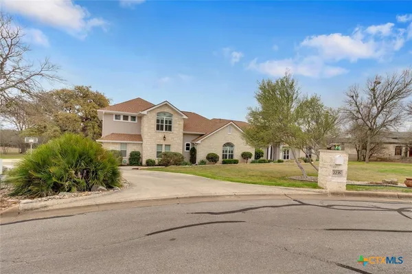a big house with a big yard and large trees