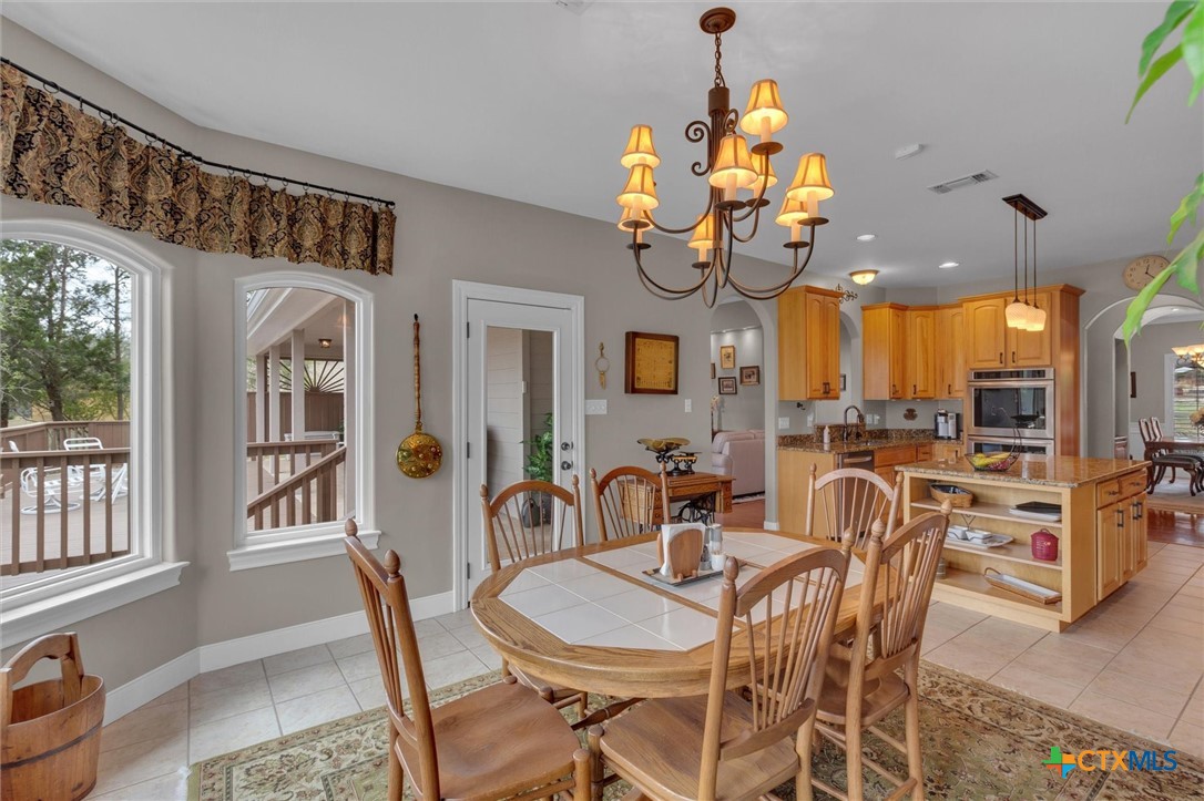 2235 Summit Ridge San Marcos, TX 78666 - Photo 11 of 38 a view of a dining room furniture and a chandelier
