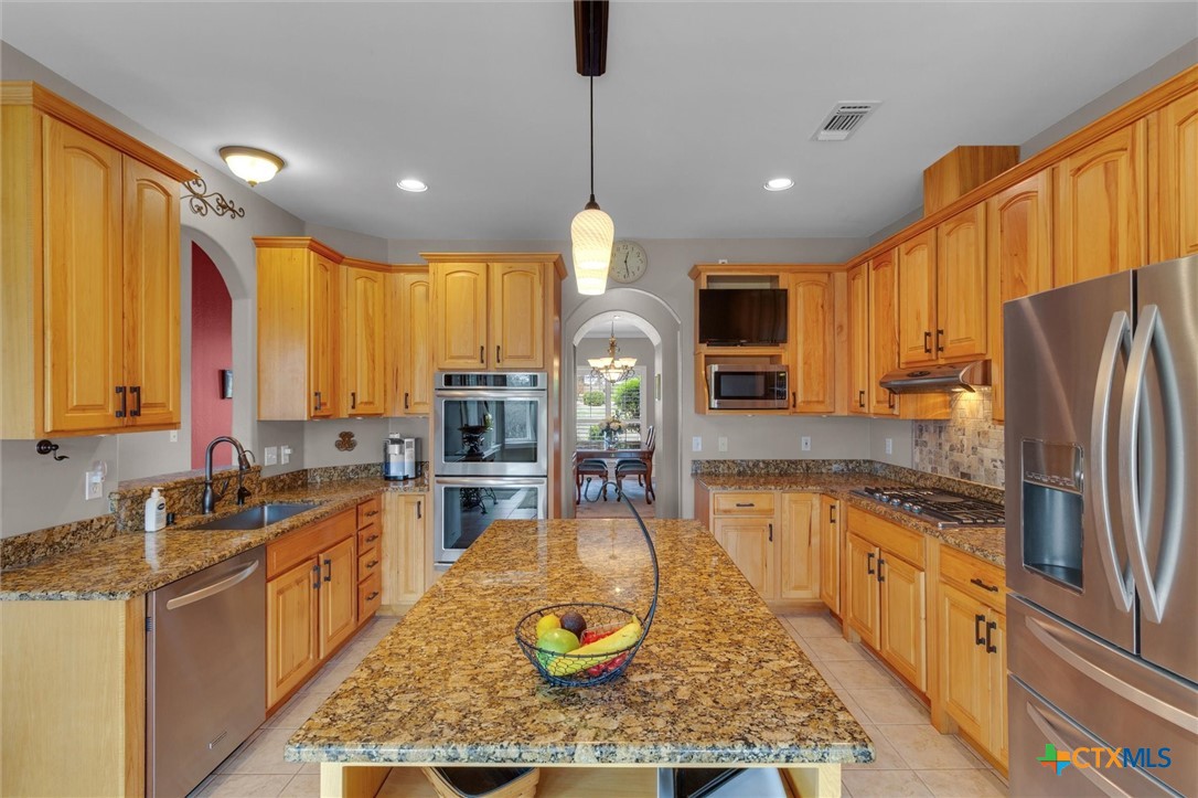 2235 Summit Ridge San Marcos, TX 78666 - Photo 12 of 38 a kitchen with stainless steel appliances granite countertop sink stove refrigerator and cabinets