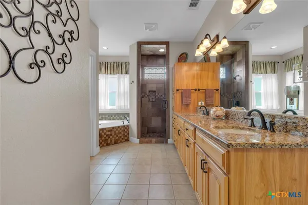 a bedroom with a bed and a ceiling fan