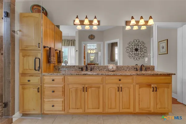 a bathroom with a sink a light fixture and a mirror