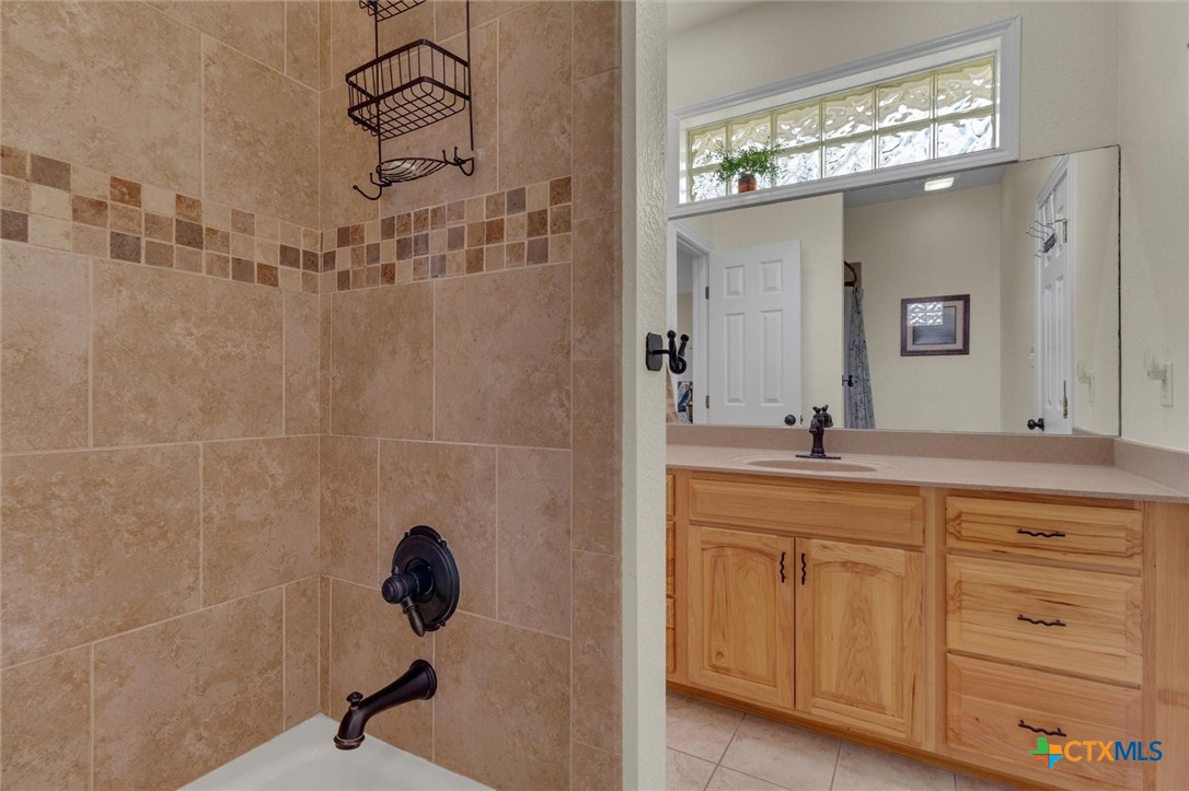 2235 Summit Ridge San Marcos, TX 78666 - Photo 27 of 38 a bathroom with a sink a light fixture and a mirror