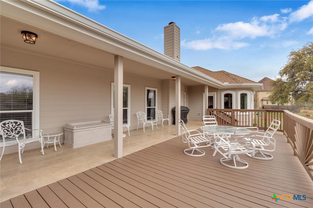 2235 Summit Ridge San Marcos, TX 78666 - Photo 34 of 38 a view of a patio with table chairs and wooden floor