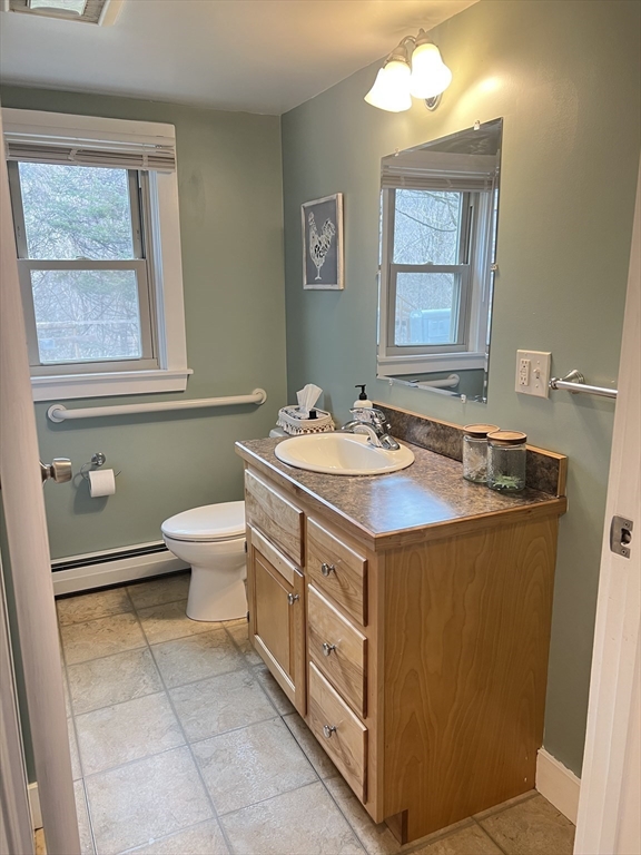 300 Main Road Colrain, MA 01340 - Photo 12 of 41 a bathroom with a sink a toilet and mirror