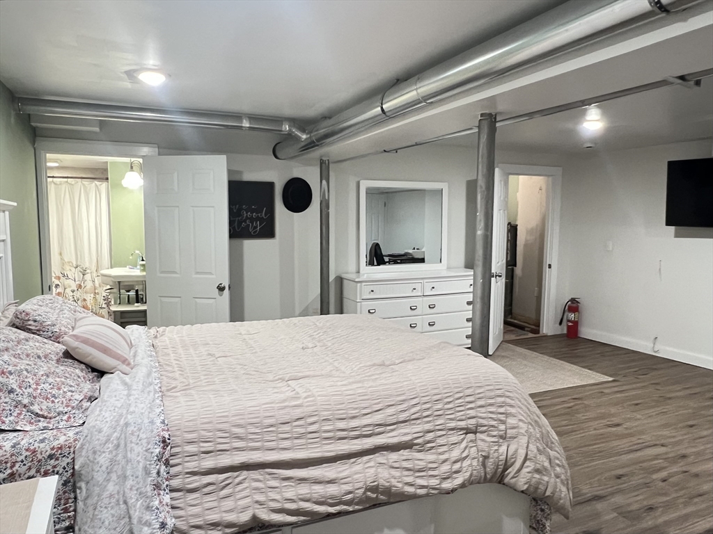 300 Main Road Colrain, MA 01340 - Photo 28 of 41 a large bedroom with a bed and a large mirror