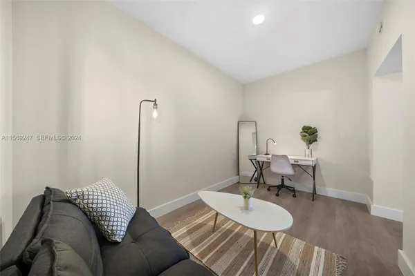 a living room with a couch and a rug