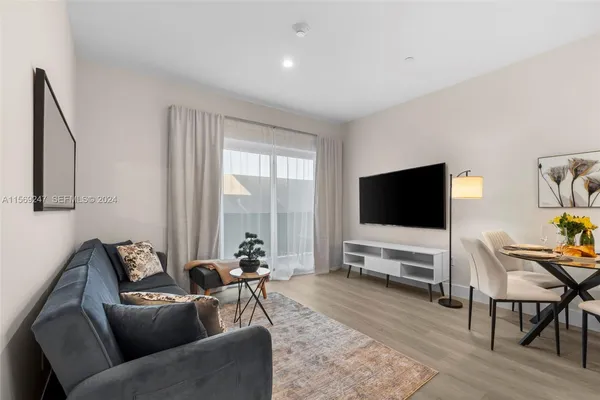 a view of a livingroom with furniture and a flat screen tv