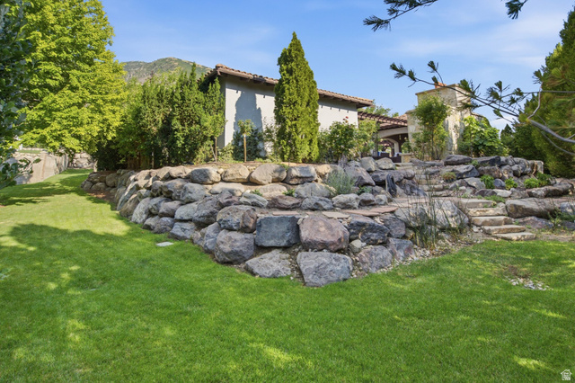 12308 Mariah Circle Draper, UT 84020 - Photo 253 of 293 Expansive terraced landscaping featuring a rock retaining wall and stone steps