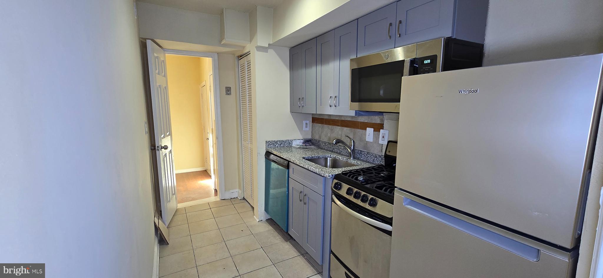 a kitchen with a stove and a refrigerator