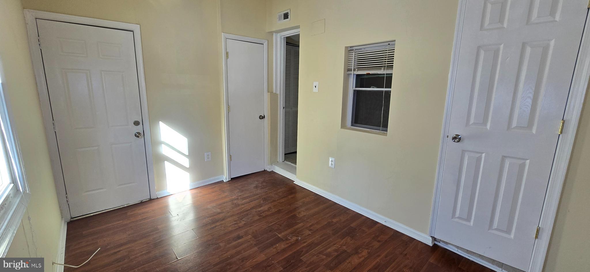 1255 Meigs Place Northeast, Unit 3 Washington, DC 20002 - Photo 11 of 13 a view of an empty room with wooden floor and a window
