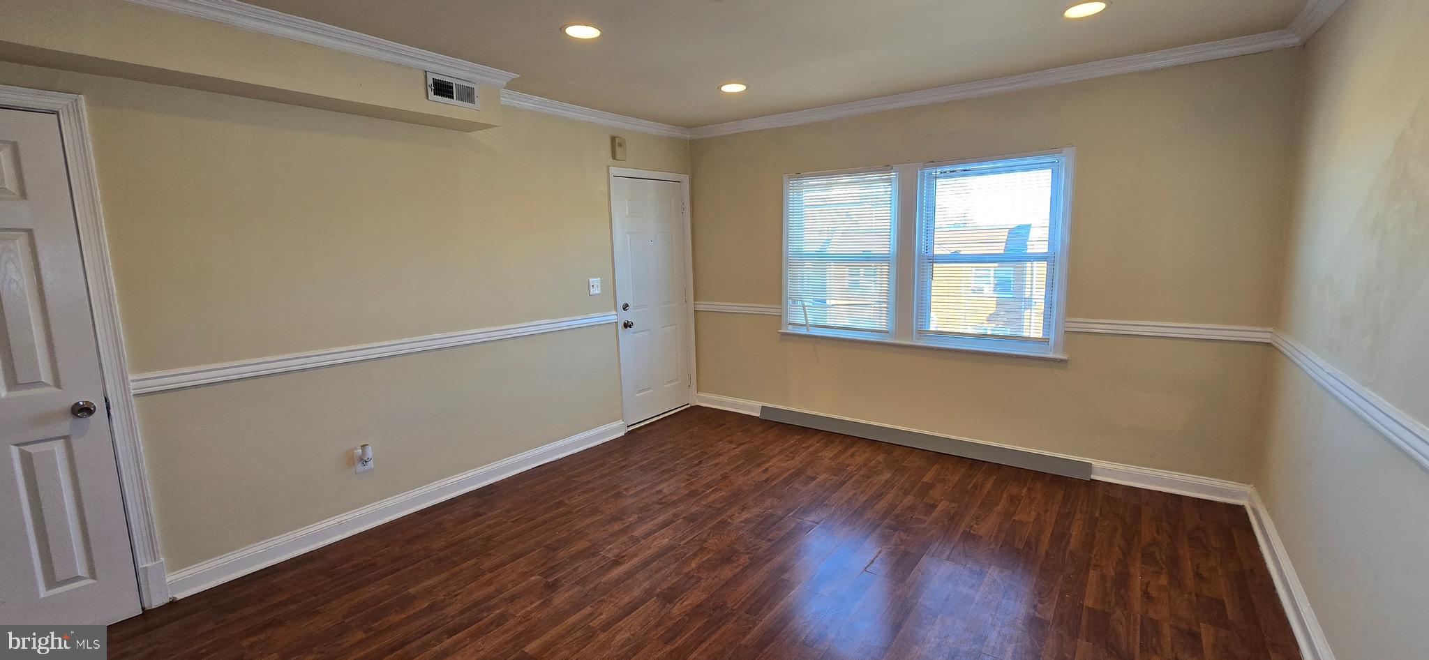 1255 Meigs Place Northeast, Unit 3 Washington, DC 20002 - Photo 3 of 13 a view of an empty room with wooden floor and a window