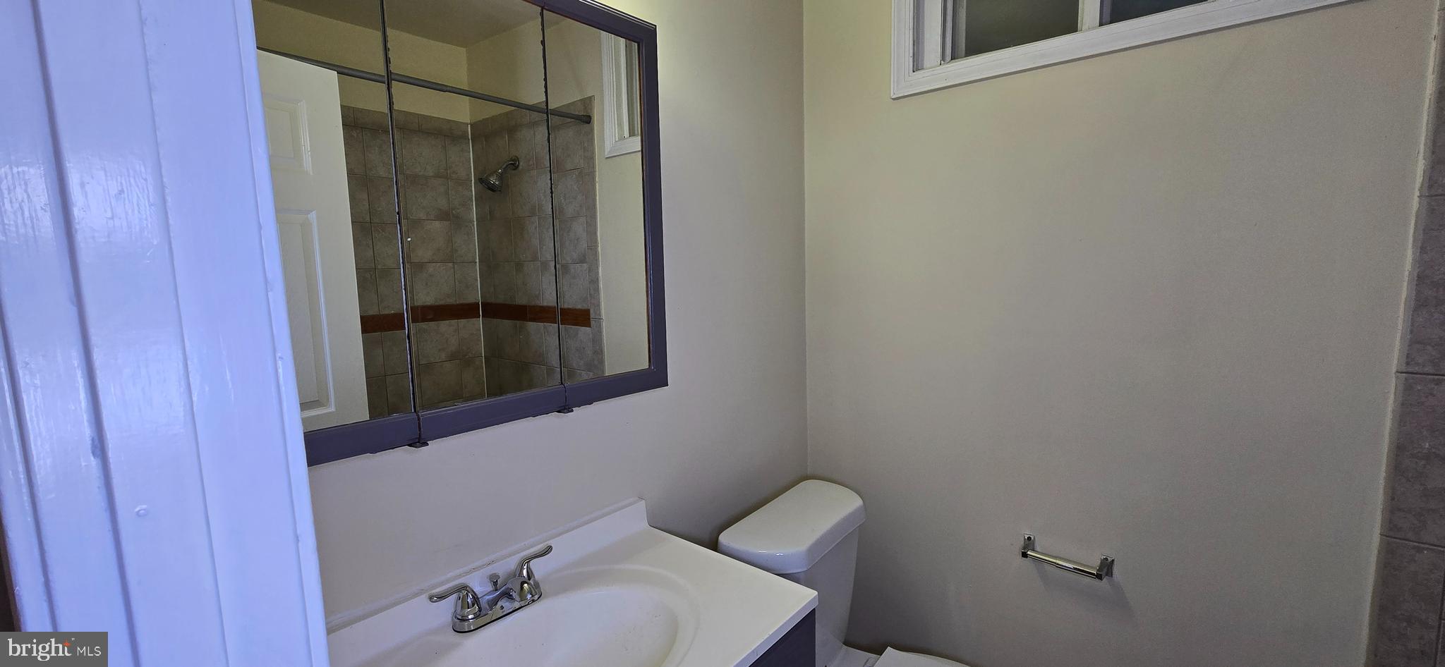 1255 Meigs Place Northeast, Unit 3 Washington, DC 20002 - Photo 5 of 13 a bathroom with a sink and mirror