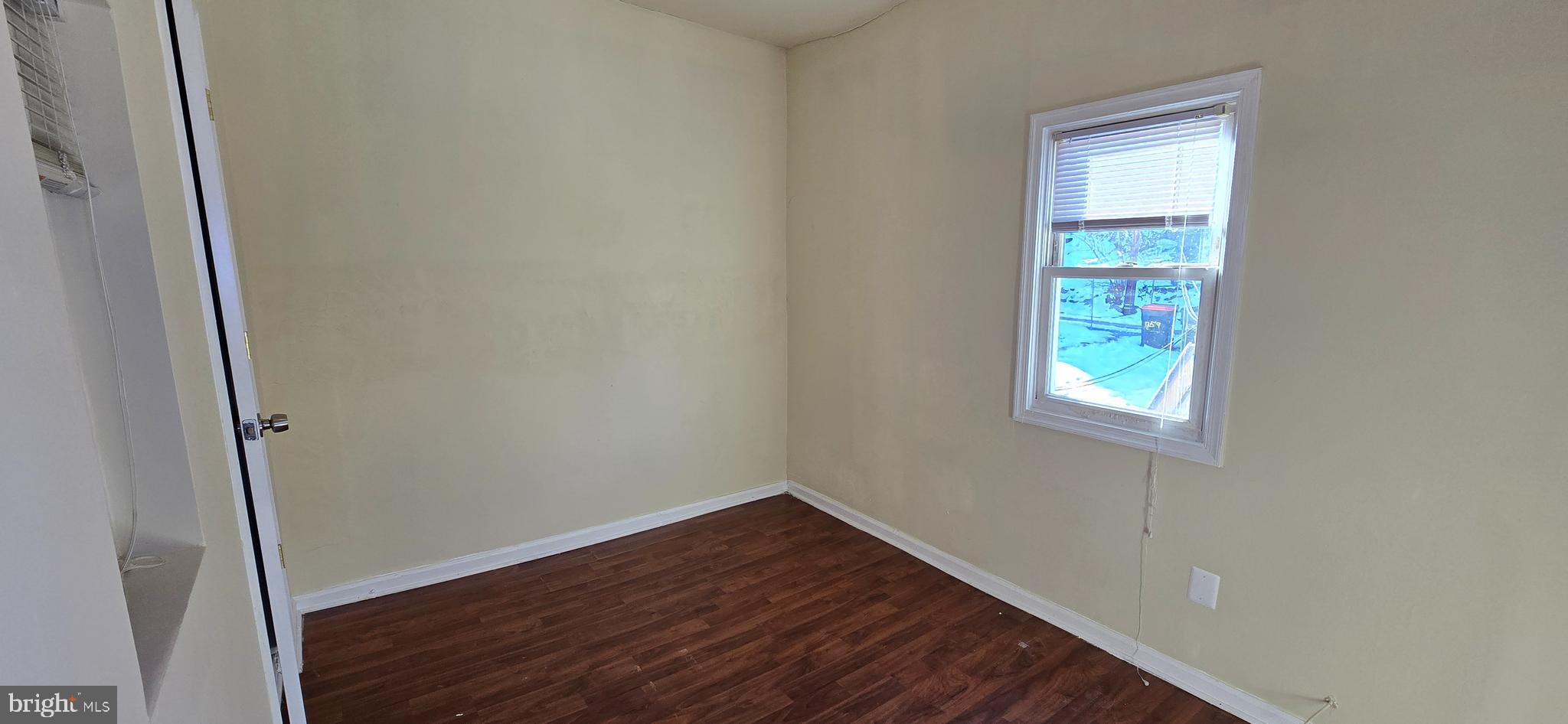 1255 Meigs Place Northeast, Unit 3 Washington, DC 20002 - Photo 9 of 13 an empty room with wooden floor and window