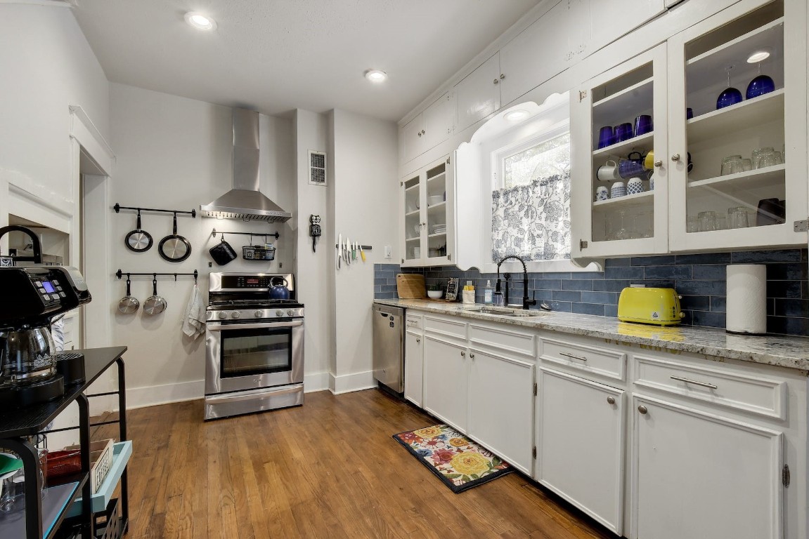 712 East 44th Street, Unit A Austin, TX 78751 - Photo 23 of 40 a kitchen with stainless steel appliances a sink cabinets and wooden floor